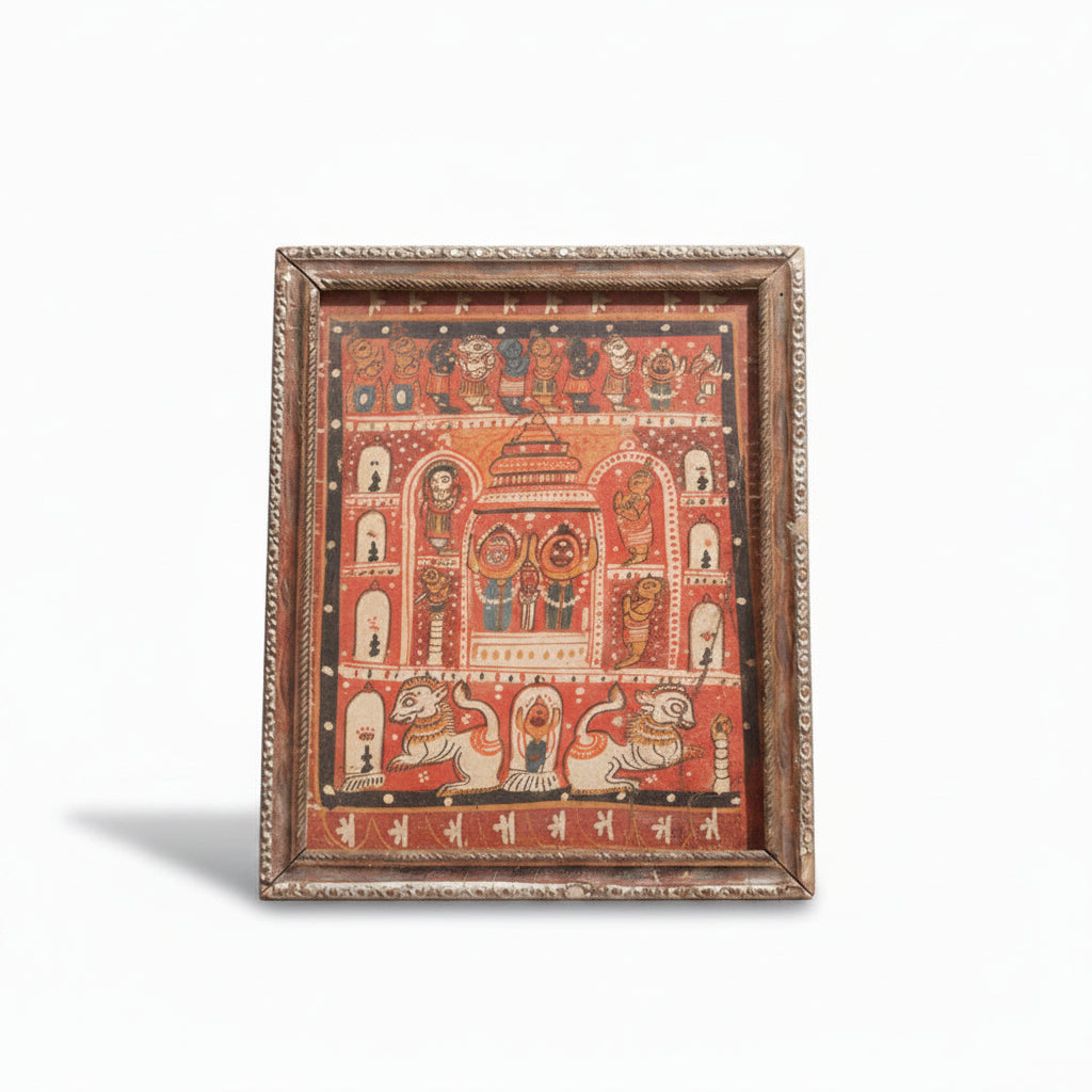 Framed traditional artwork with intricate designs on a beige wall